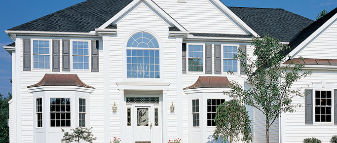 Two-story white home with double-hung windows throughout
